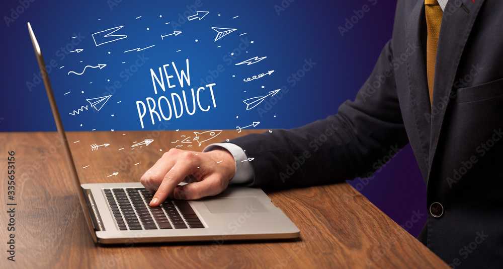 Businessman working on laptop with NEW PRODUCT inscription, online shopping concept Businessman working on laptop with NEW PRODUCT inscription, online shopping concept