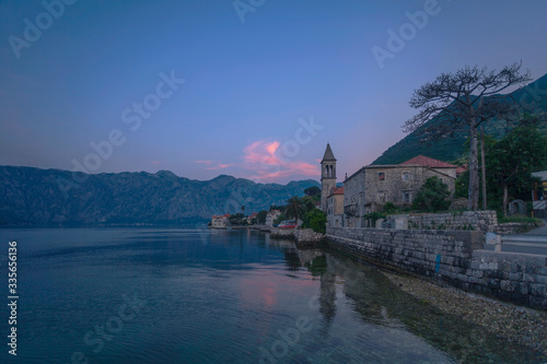 Old seaside town at sunset and mountains