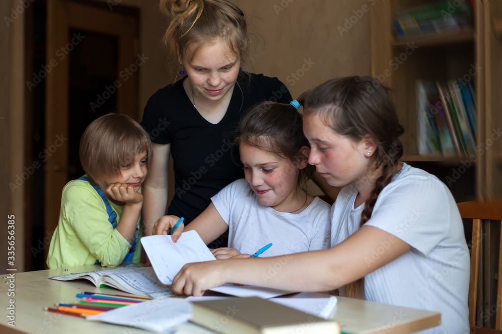 girls doing homework at table girls doing homework at table