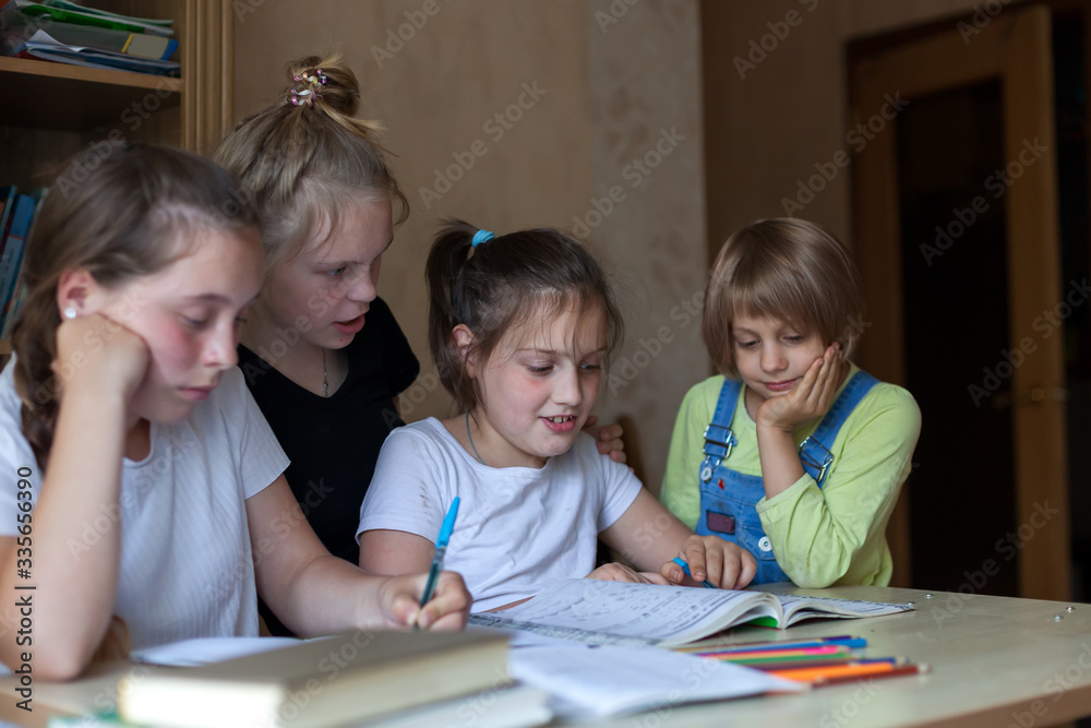 Four girls at desk with notebooks and books Four girls at desk with notebooks and books