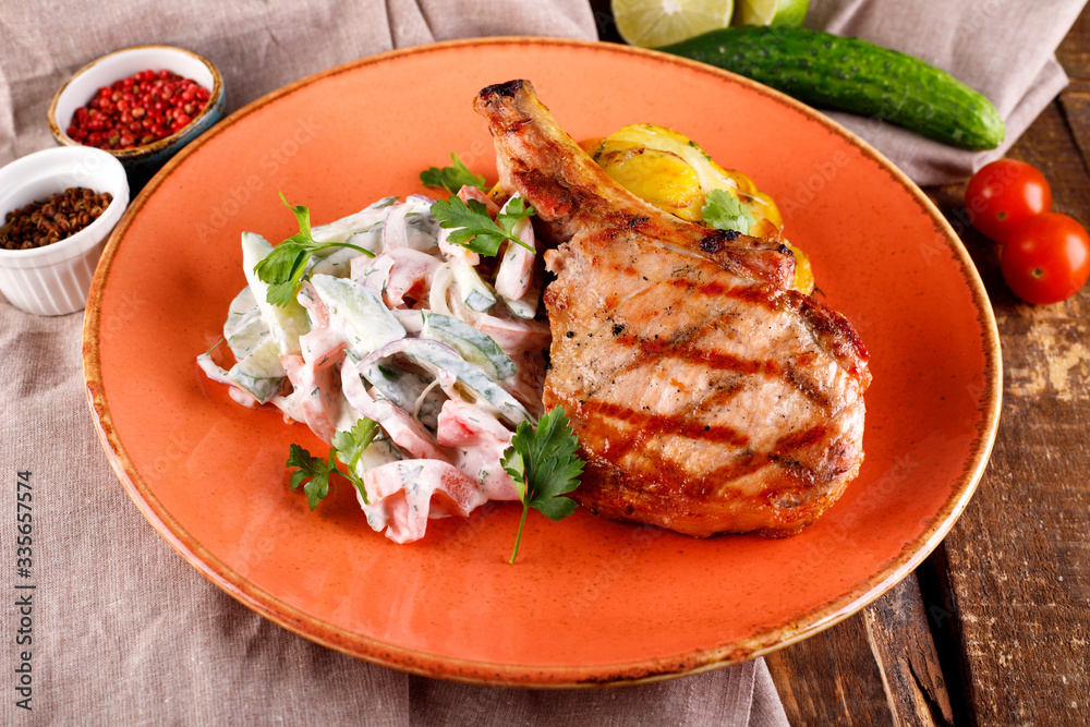 Roast pork loin served with vegetables in sauce Roast pork loin served with vegetables in sauce