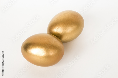 Golden easter eggs isolated on white background. Decorative easter decorations. Easter card. Flat layout.