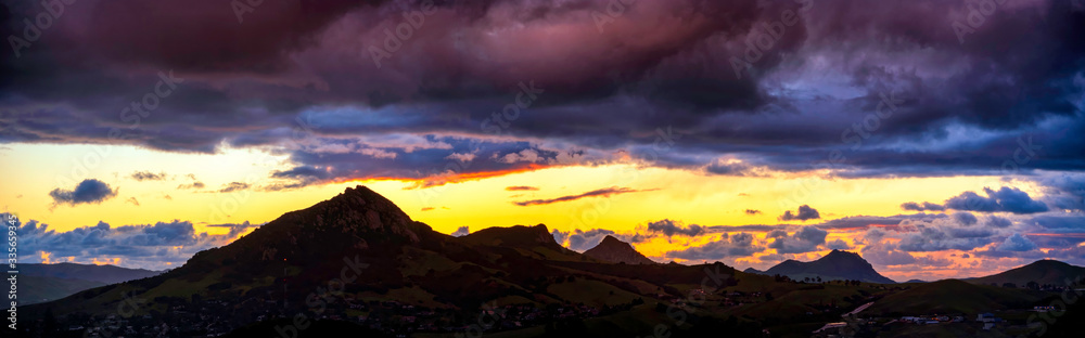 Panoramic sunset over Silhouetted Mountains 