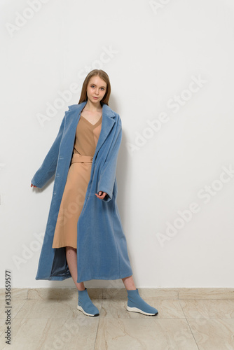 young woman in coat on white backgound