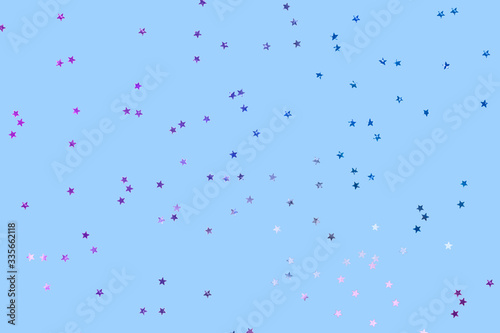 Falling confetti background. Sparkles on pastel blue trendy background. Festive backdrop for your projects.