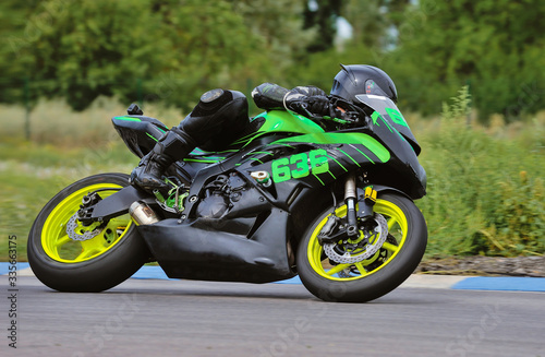 Motorcycle practice leaning into a fast corner on track