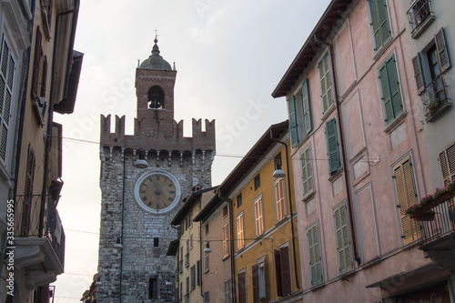 Narrow street with upper facad of Torre della Pallata  Brescia Old Town  Lombardy  Italy.