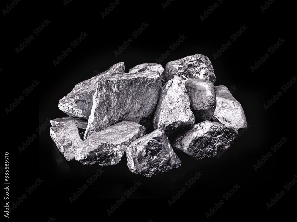 piece of silver or platinum on the stone floor, on black background. Export ore from south africa