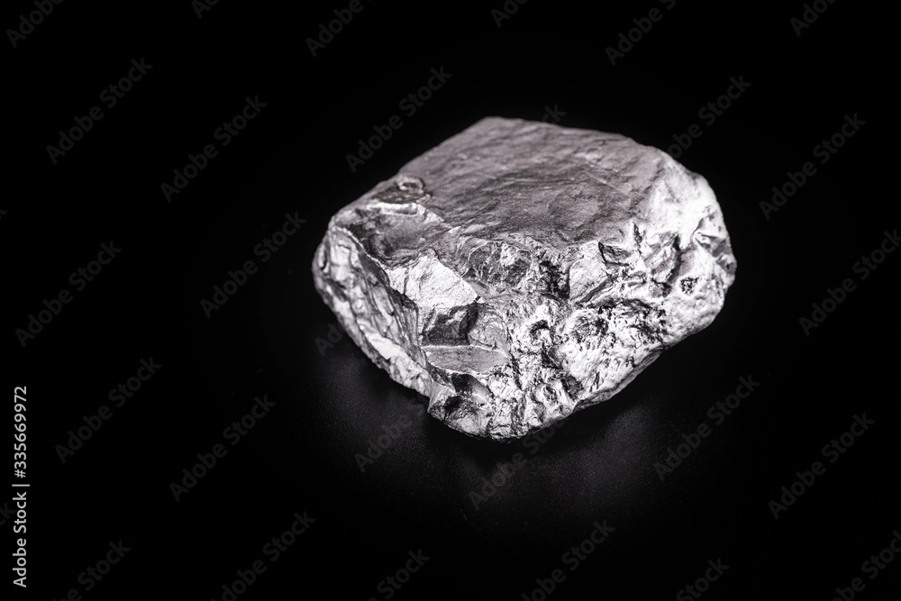 small titanium stone, metal used in light alloys. Macro photography of rough ore.
