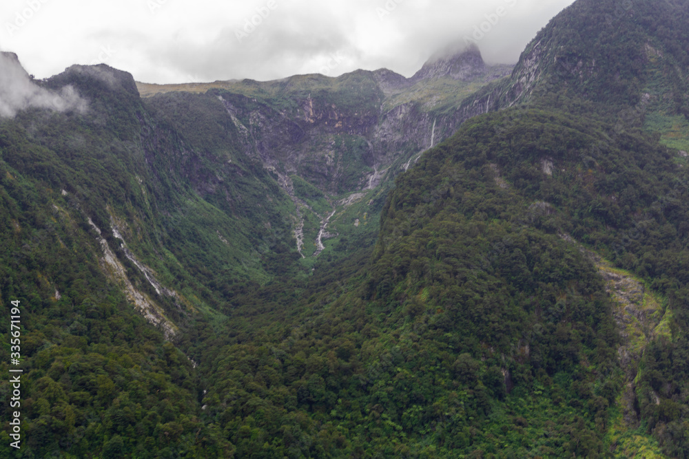 Naklejka premium Fiords Mountans Hills Sea Waterfall Boat Fiorland Milford Sound Doubtful Sound New Zealand 