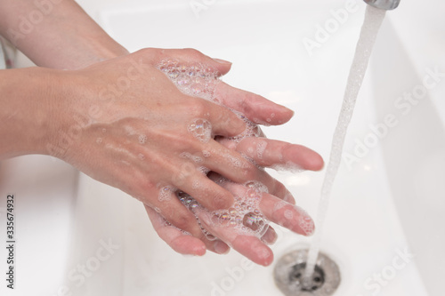 woman washing her hands with soap