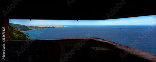 Scenic views of seascapes and mountains of West Oahu from inside WW2 Pillbox atop of the Waianae Mountain ridge. Grafitti painted on the inside walls and with large open dark areas for text