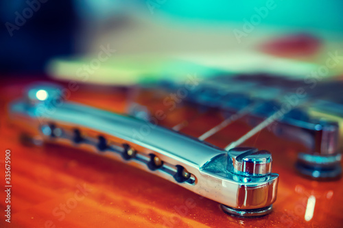 Close up of an electric guitar chromed bridge