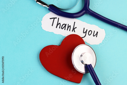 Canvastavla medical stethoscope, healthy red heart and the inscription Thank you on a blue b