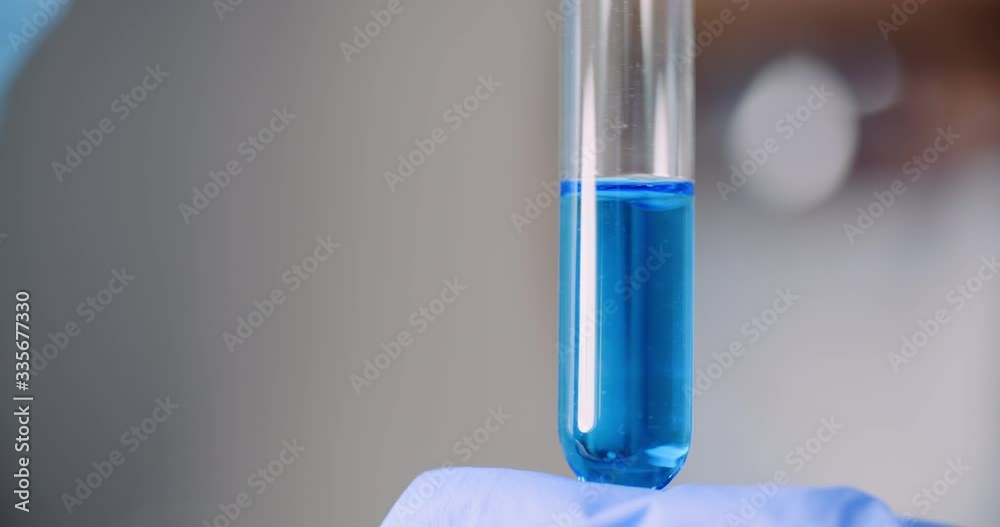 Working in Laboratory - Scientist Using Holding Test Tubes in Hand. Working in Laboratory - Scientist Using Holding Test Tubes in Hand.