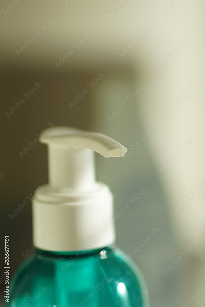Closeup aquamarine gel bottle with white dispenser. Closeup aquamarine gel bottle with white dispenser.