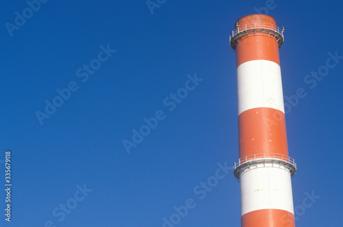 A red and white smoke stack at the Scattergood steam plant in Los Angeles, CA
