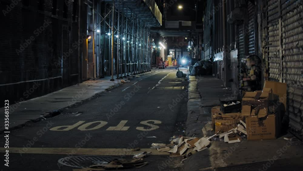 Urban New York City scenery, Manhattan narrow street by night, slow motion of people passing  