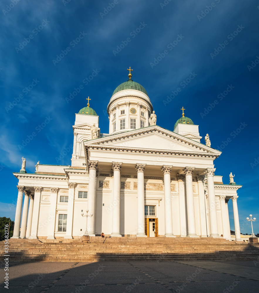 Finnish St Nicholas Cathedral is famous church in neoclassical style with iconic green dome, historical center of Helsinki, Finland. Sunset time