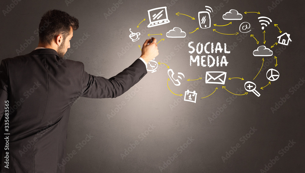 businessman drawing social media icons with SOCIAL MEDIA inscription, new media concept businessman drawing social media icons with SOCIAL MEDIA inscription, new media concept