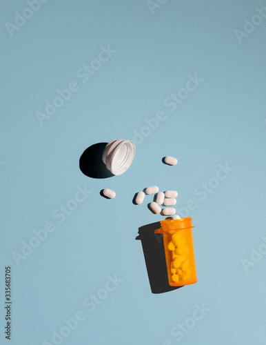 Pills Spilling Out of a Medicine Bottle photo