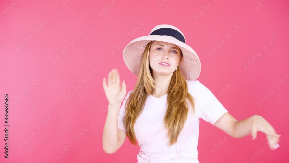 Beautiful woman wears hat while dancing on studio Beautiful woman wears hat while dancing on studio