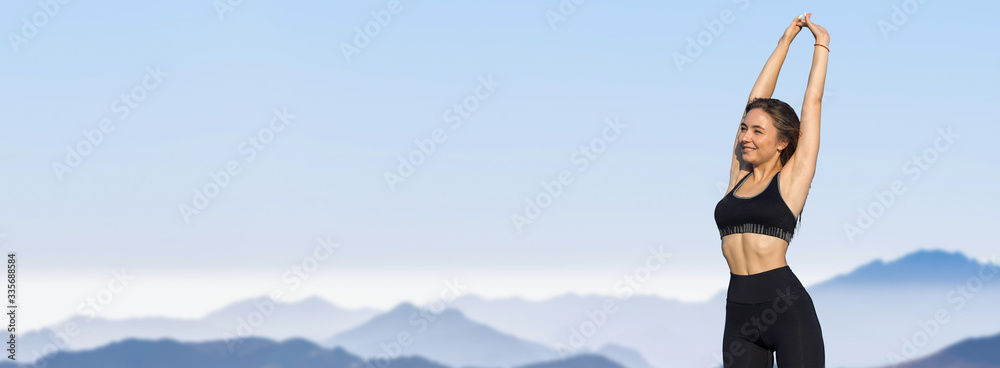 A thin athletic girl takes a break between classes on the background of mountains in the early morning, enjoys silence and freedom. A thin athletic girl takes a break between classes on the background of mountains in the early morning, enjoys silence and freedom.