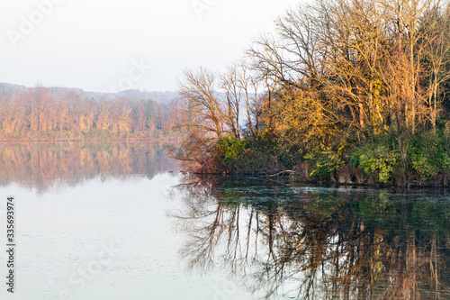 Autumn landscape featuring colorful trees reflecting in a lake in eastern Pennsylvania photo