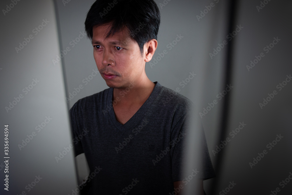 Young Asian man working with desktop computer at home, Work from home concept. Young Asian man working with desktop computer at home, Work from home concept.