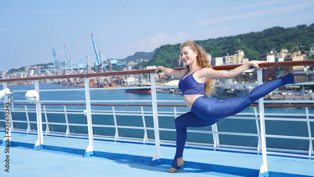 Beautiful slender curly-haired girl on observation deck of ship ...