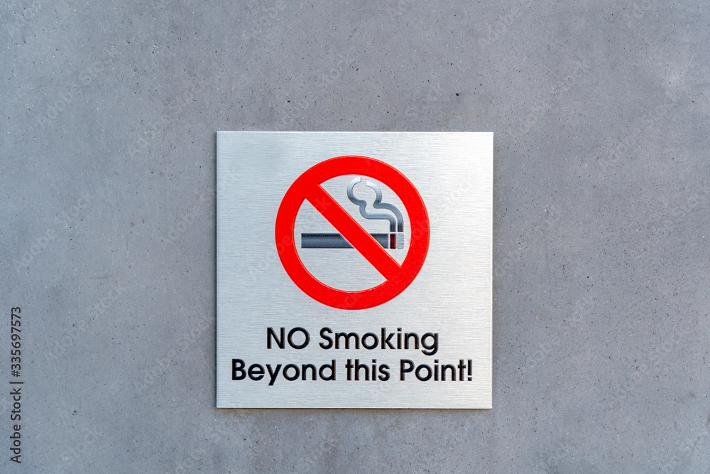 No Smoking Beyond this Point metal sign plate on a wall No Smoking Beyond this Point metal sign plate on a wall