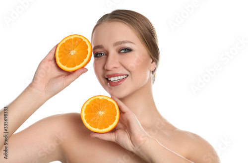 Young woman with cut orange on white background. Vitamin rich food