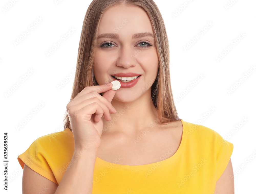 Young woman taking vitamin pill on white background Young woman taking vitamin pill on white background