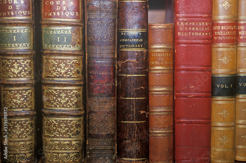 Row of Antique books on shelf photo