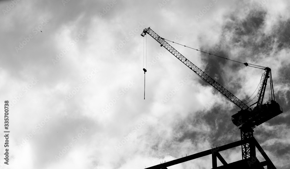 Construction crane on high rise building Construction crane on high rise building