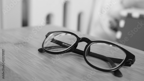 Eyeglasses on wooden desk