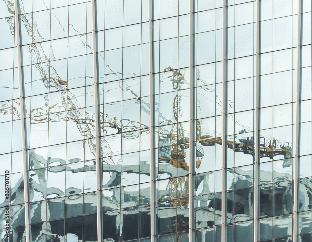 Modern office buildings with glass facade reflecting their surroundings 