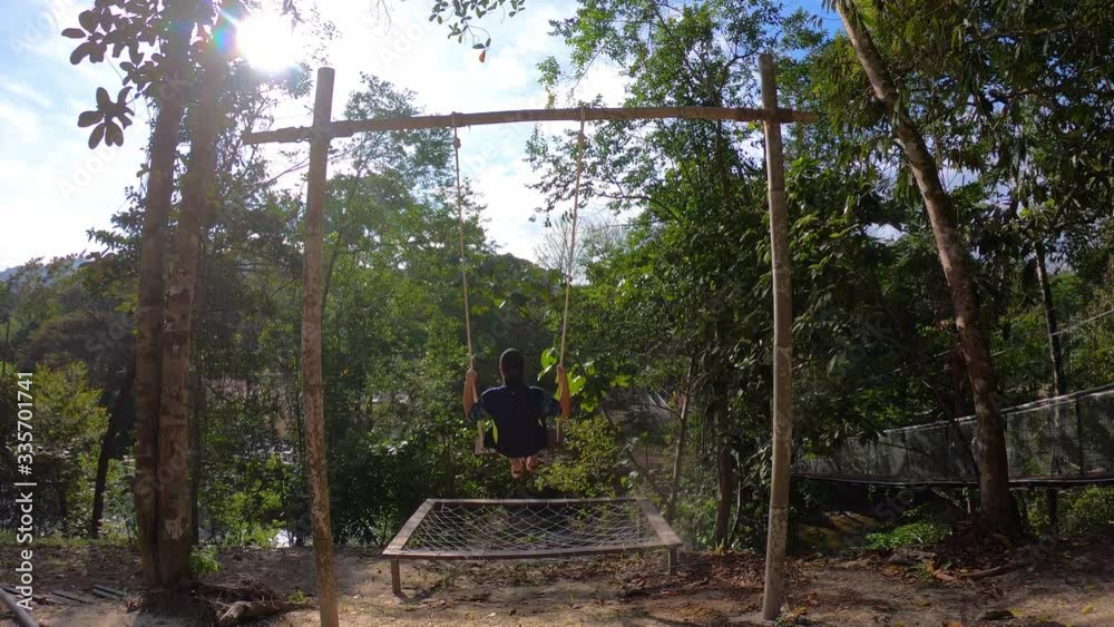 Man sitting on rope swing Man sitting on rope swing