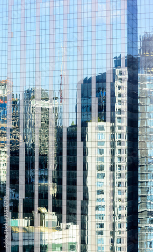 Modern office buildings with glass facade reflecting their surroundings 