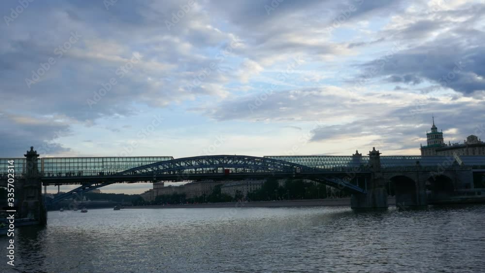 Crowd of people walking inside Pushkinskiy glass Bridge above Moskva river Crowd of people walking inside Pushkinskiy glass Bridge above Moskva river