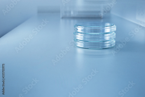 three petri dish or plate for microbiology study in blue medical health science laboratory background