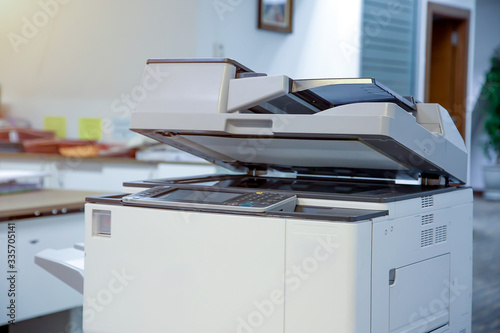 The photocopier or network printer is office worker tool equipment for scanning and copy paper. photo