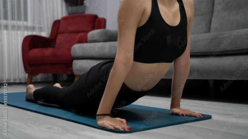 Young woman does exercises from home during quarantine time at coronavirus. Young woman does exercises from home during quarantine time at coronavirus.