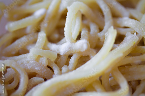 Spoiled spaghetti with mold. Pasta or noodles with white penicillum spores. Old food close up background photo