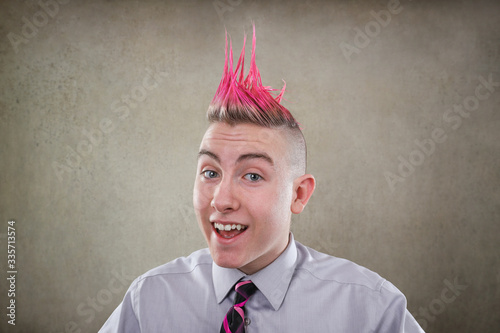 Smiling teen with a pink mohawk haircut photo