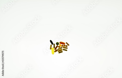 Medicine and vitamin tablets isolated against a white background