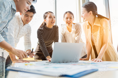 Group of asian young modern people in smart casual wear having a brainstorm meeting while sitting in office background. Business meeting, Planning, Strategy, New business development, Startup concept.