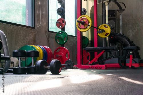 Lots of functional equipment in cross-training gyms, including squat racks, barbell weights, and a wide variety of equipment in colorful gyms.