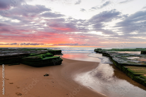Red clouds on sunrise time at Turimetta Beach, Sydney.