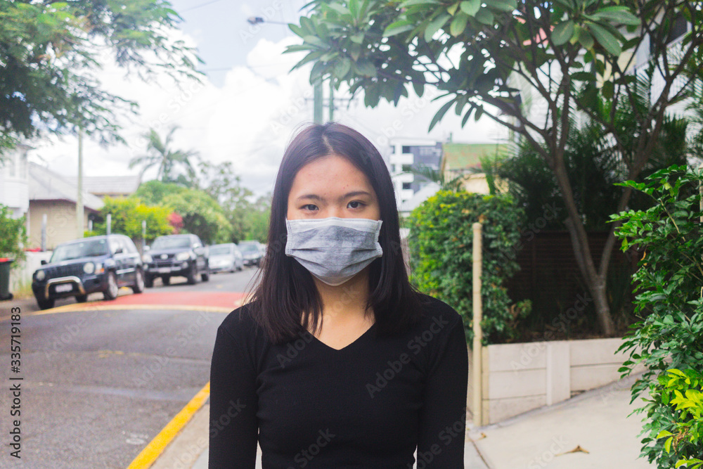 Asian young girl in city street wearing face mask protective. Asian young girl in city street wearing face mask protective.